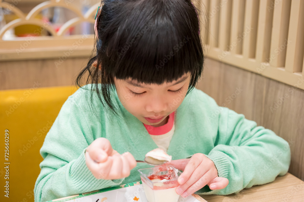 Cute little asian child girl eating food Cute little asian child girl eating food