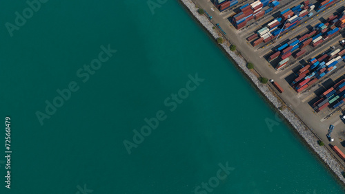 container,container ship in import export and business logistic.By crane , Trade Port , Shipping.Tugboat assisting cargo to harbor.Aerial view. © eakarat