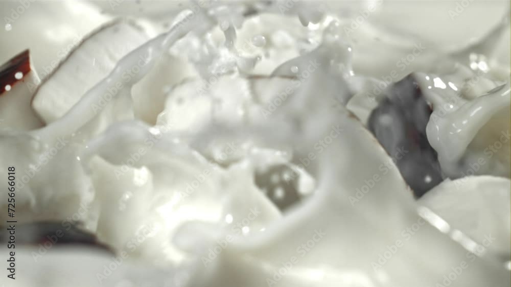 Pieces of coconut fall into the milk with splashes. Filmed on a high-speed camera at 1000 fps. High quality FullHD footage Pieces of coconut fall into the milk with splashes. Filmed on a high-speed camera at 1000 fps. High quality FullHD footage