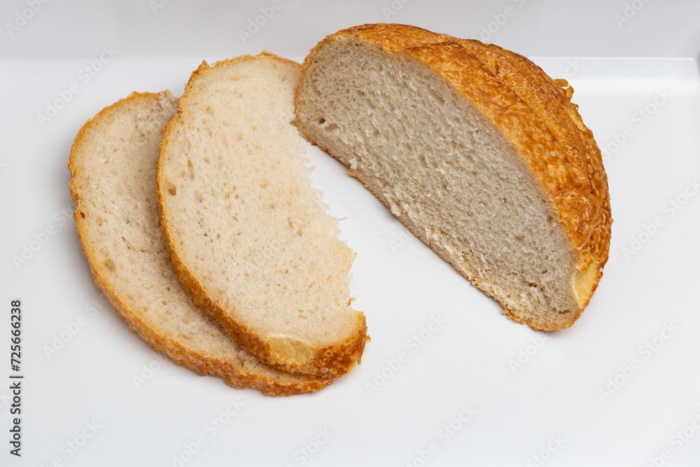 Sliced loaf of freshly baked sourdough bread with a shallow depth of field
