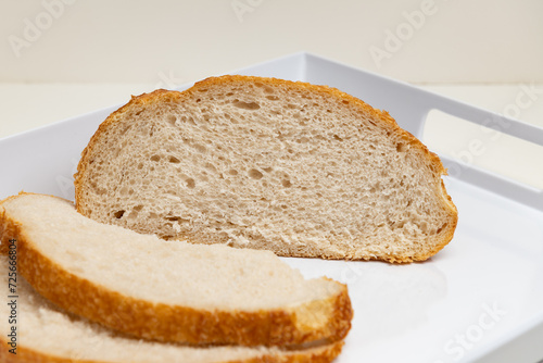 Sliced loaf of freshly baked sourdough bread with a shallow depth of field 