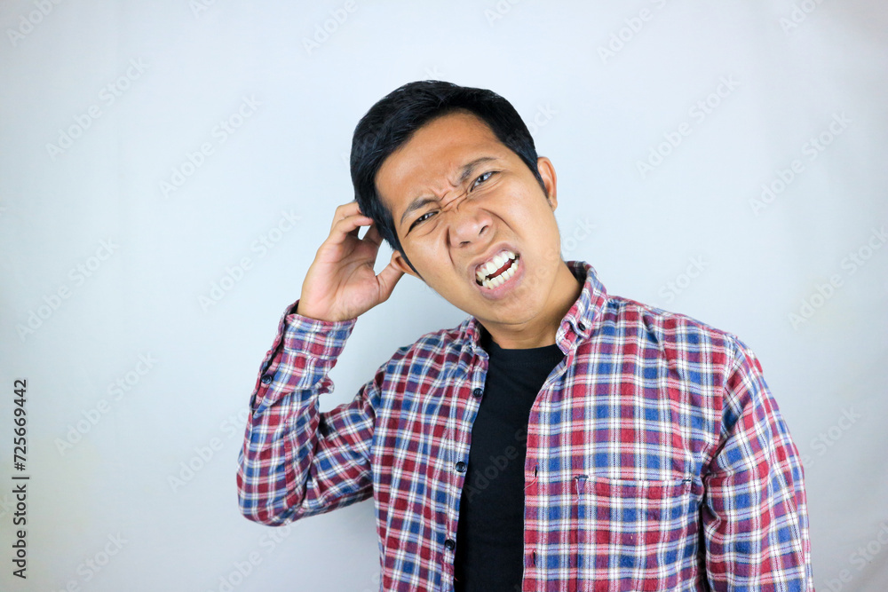 funny facial expression of asian man confused and scratching his head, questioning the problem funny facial expression of asian man confused and scratching his head, questioning the problem