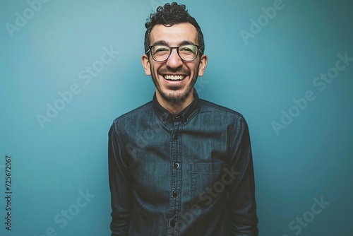 a man wearing glasses and smiling