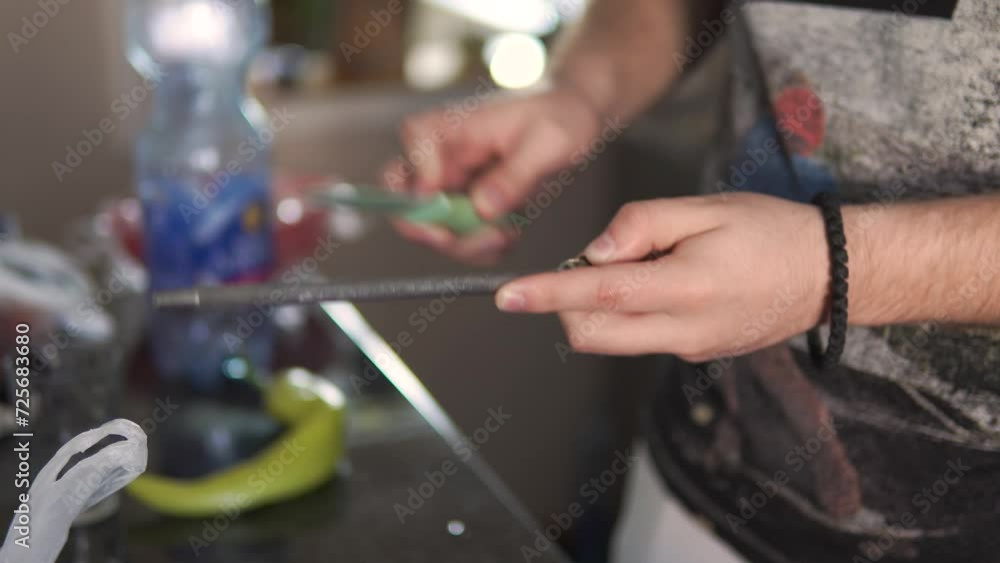 a man is sharpening a knife in the kitchen a man is sharpening a knife in the kitchen