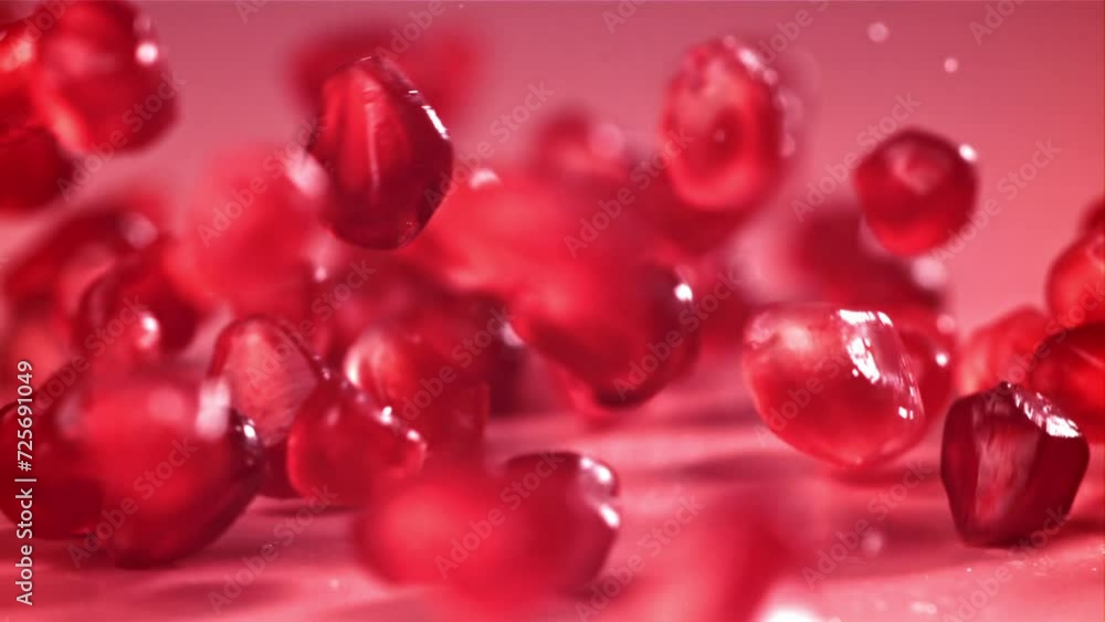 Pomegranate seeds fall on the table with splashes. Filmed on a high-speed camera at 1000 fps. High quality FullHD footage Pomegranate seeds fall on the table with splashes. Filmed on a high-speed camera at 1000 fps. High quality FullHD footage