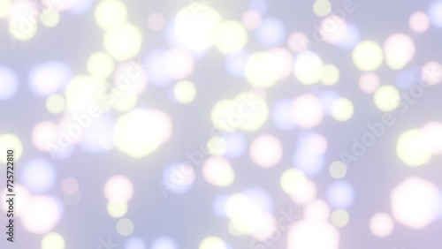 Defocused bokeh particles lights on light grey background 4K loop