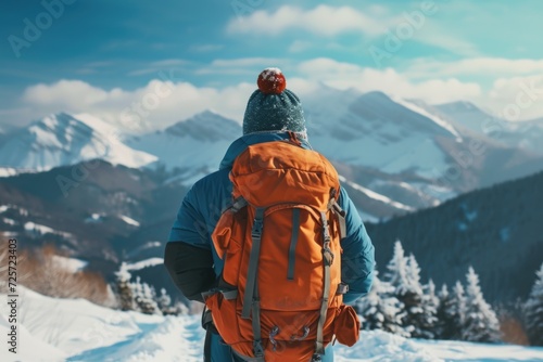 A person standing in the snow with a backpack. This image can be used to depict winter activities or outdoor adventures