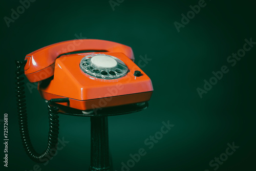 An old red telephone with a rotary dial, an old historical red telephone, still life of an old red telephone photo