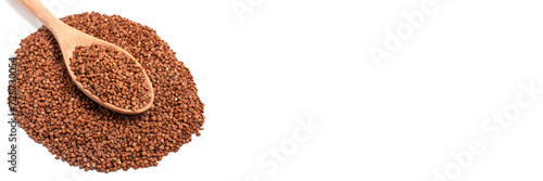 Dry buckwheat in wooden spoon isolated on white background. Banner.