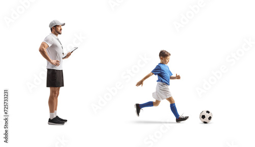 Fototapeta Naklejka Na Ścianę i Meble -  Football coach watching a boy at training
