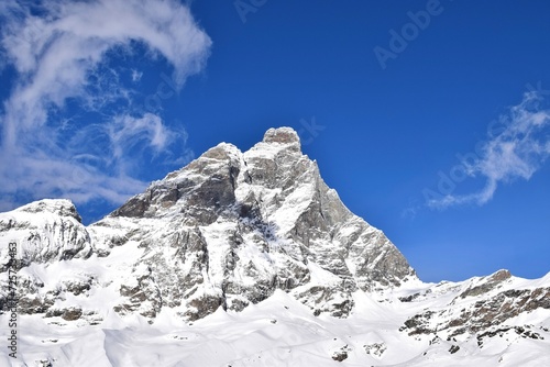 Beautiful snowcapped Matterhorn from ski slopes in Cervinia Valtournenche ski resort, Italian Alps. Snowy mountain peak that borders Italy and Switzerland. © Elenitsa