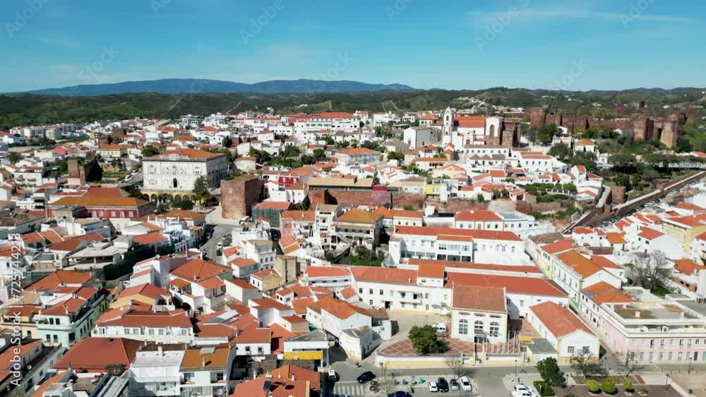 Hill town of Silves, Algarve, Portugal during spring, cobbled streets and orange roofs by 4K drone Hill town of Silves, Algarve, Portugal during spring, cobbled streets and orange roofs by 4K drone