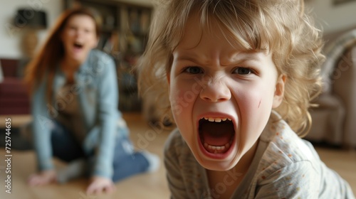 Little girl screams next to her mother, child aggression