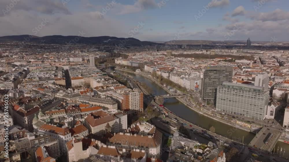 Aerial view of buildings in urban boroughs along river. Busy roads on waterfronts. Metropolis at golden hour. Vienna, Austria Aerial view of buildings in urban boroughs along river. Busy roads on waterfronts. Metropolis at golden hour. Vienna, Austria