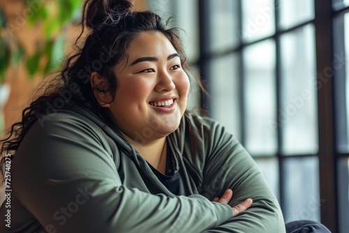 Happy Asian plus size woman exercising and relaxing in comfortable sportswear. photo