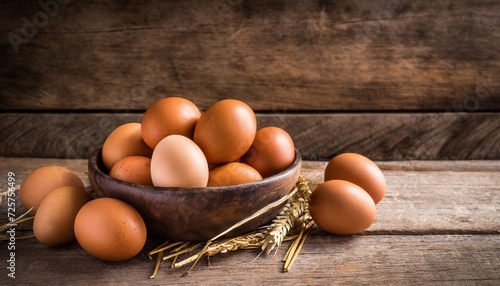 Brown chicken eggs in bowl and on wooden table. Fresh and organic farm product