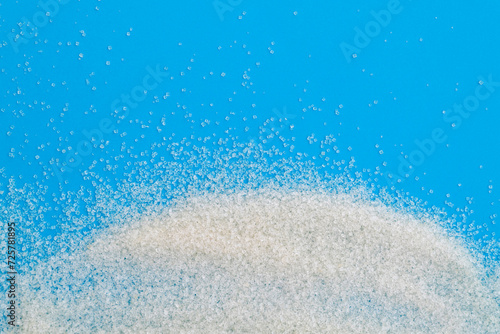White sugar crystals on blue background