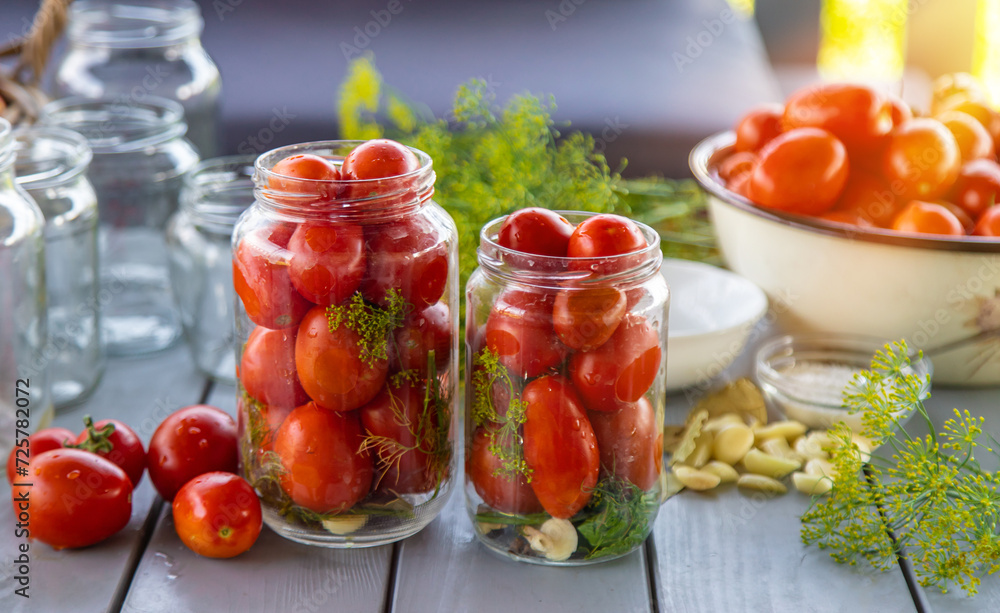 Preserving tomatoes in jars. Selective focus. Preserving tomatoes in jars. Selective focus.