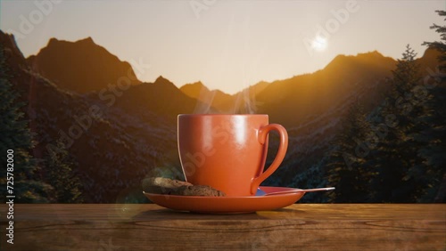 A cup of steaming coffee against the backdrop of sunrise. Cup with saucer and cookies on a wooden parapet. Behind her are forested mountains, above which an orange sun rises in the haze. Close up. photo