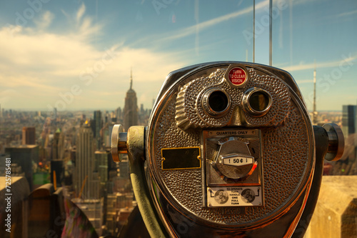 Photography A close-up of coin-operated viewing binoculars invites onlookers to take in the expansive New York City skyline