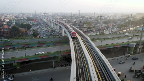  Drone drone following the metro on its track while flying over the track.