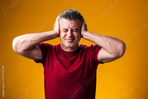 Man suffering from headache desperate and stressed because pain and migraine. Hands on head. People, healthcare and medicine concept