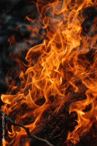 A close-up view of fire burning brightly against a black background. This image can be used to depict concepts such as warmth, energy, power, danger, and passion.