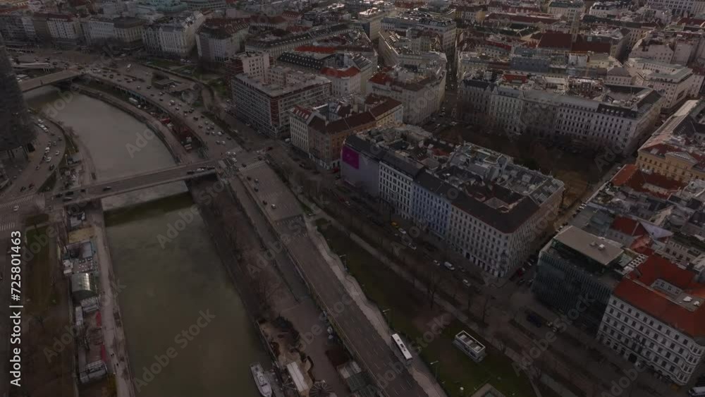 High angle view of waterfront in city. Tilt up reveal cityscape with historic tourist landmarks. Tall tower of Stephansdom. Vienna, Austria High angle view of waterfront in city. Tilt up reveal cityscape with historic tourist landmarks. Tall tower of Stephansdom. Vienna, Austria