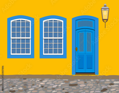 Paraty, Brazil. Facade of yellow house with blue doors and windows from the colonial period and cobblestone street in the historic center. Realistic vector illustration.