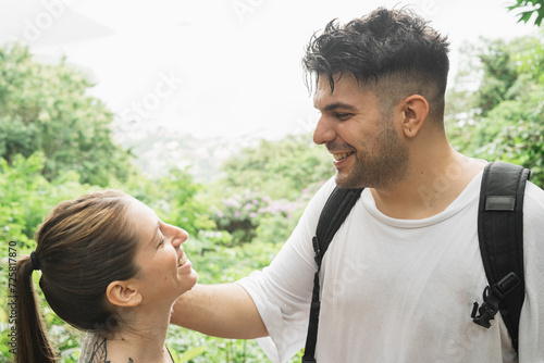 portrait of a white couple smiling at each other in nature photo