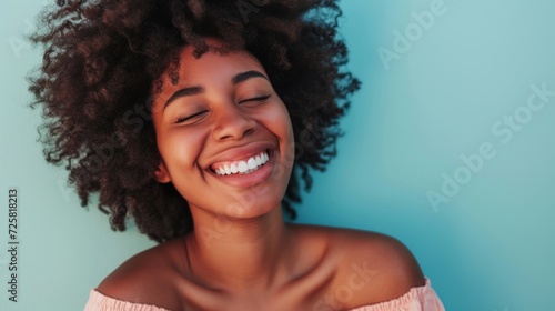 Closeup portrait of a radiant afro woman in pastel attire and colorful makeup.