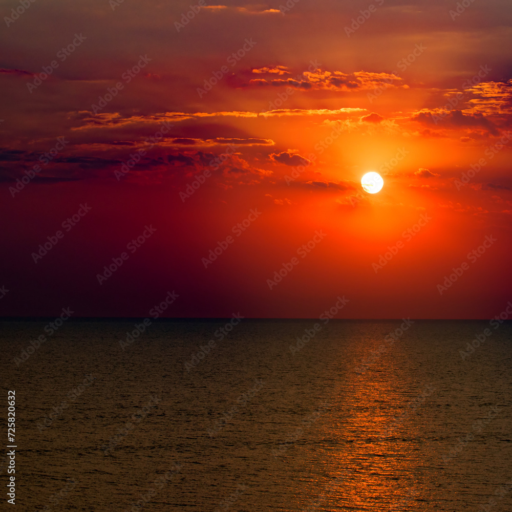 Bright red sunrise over tropical sea.
