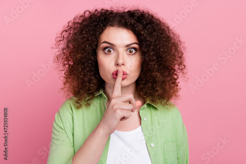 Photo portrait of pretty young girl shh silence gesture keep secret wear trendy green outfit isolated on pink color background photo