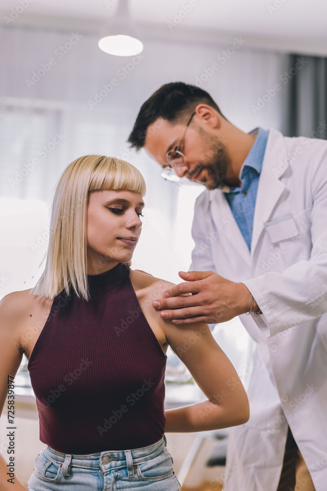 Chiropractor treating a young woman as a patient in his office. Chiropractor treating a young woman as a patient in his office.