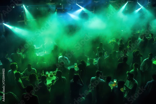 people dancing at nightclub with green emerald neon light aerial view. Night life, party and clubbing.