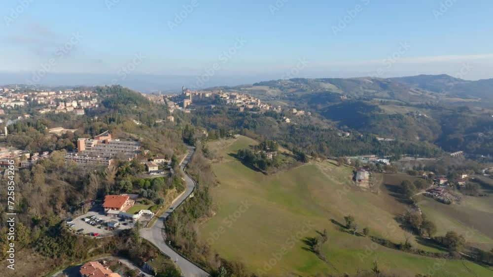 Aerial view of Urbino, the capital of the province of Pesaro and Urbino in the Marche, Italy. It was an important city in the Italian Renaissance and its historic center is a world heritage site. Aerial view of Urbino, the capital of the province of Pesaro and Urbino in the Marche, Italy. It was an important city in the Italian Renaissance and its historic center is a world heritage site.