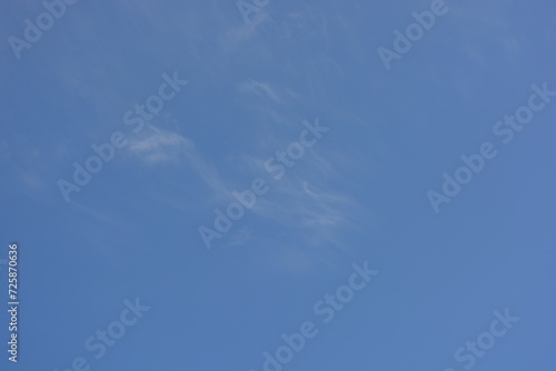 Bright and colorful photos of heavenly angelic white clouds and blue, blue sky with sunlight. Light, delicate and airy cloudy background with white and blue lights and colors.