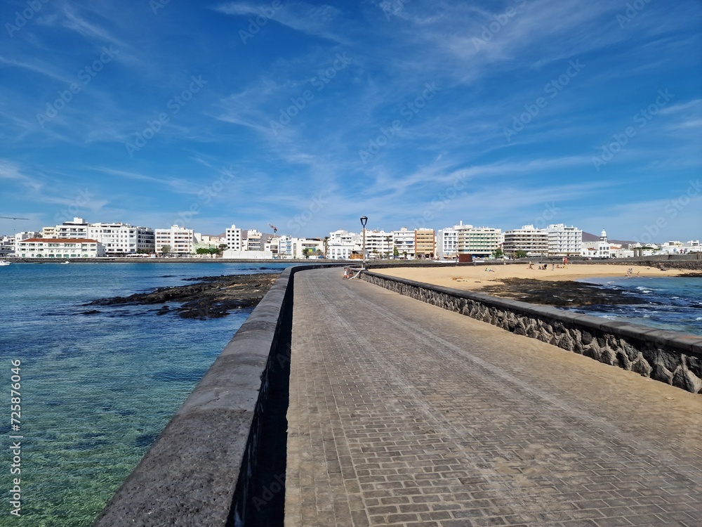 Walking the Arrecife, Lanzarote seaside promenade offers a blend of coastal charm and Canarian architecture.