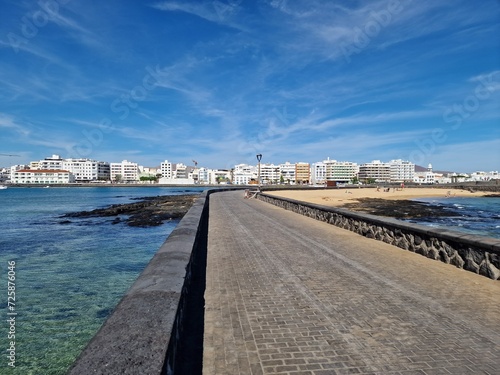 Walking the Arrecife  Lanzarote seaside promenade offers a blend of coastal charm and Canarian architecture.