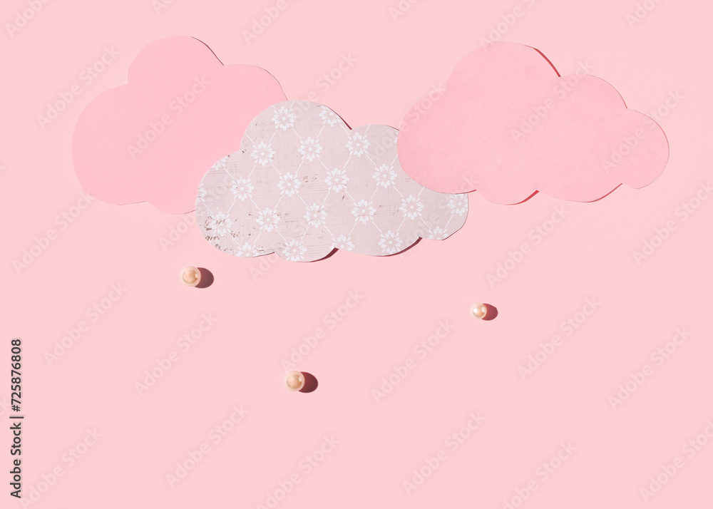 Paper clouds, pearl beads like rain, spring shower, minimal creative pastel pink concept.
