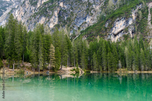 beautiful nature landscape around Lake Braies in Italy. Clear lake, trees and mountains in early spring