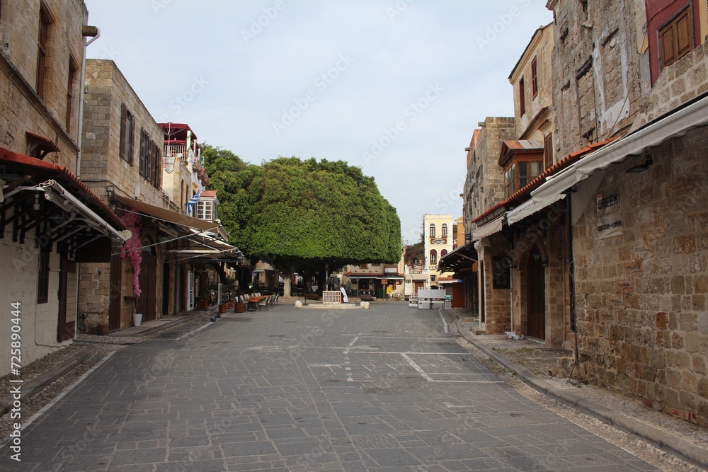 deserted street close to the Jewish martyr square in Rhodes Old town early morning in spring. all shops and restaurants are still closed.