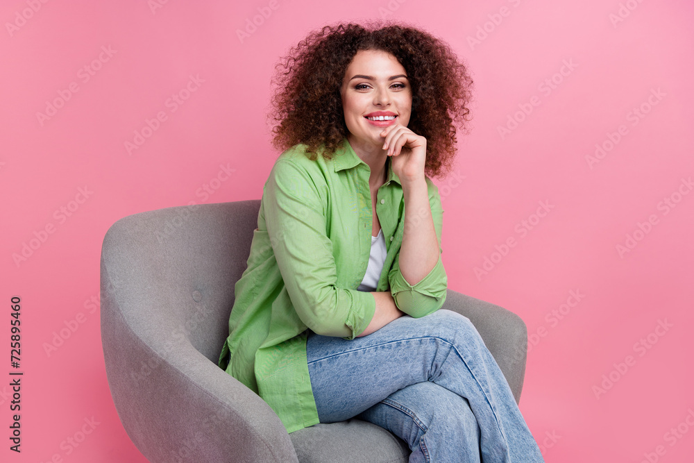 Portrait of attractive curly hair chevelure lady wearing khaki shirt touch chin smiling psychologist isolated on pink color background Portrait of attractive curly hair chevelure lady wearing khaki shirt touch chin smiling psychologist isolated on pink color background