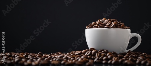 Toned cup of coffee beans on black background.