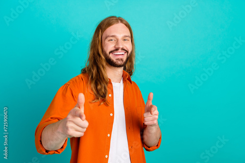 Portrait of young blond hair positive man with mustache and beard pointing fingers front to the camera isolated on blue color background