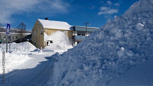 A lot of snow on the street of a village in  Norway