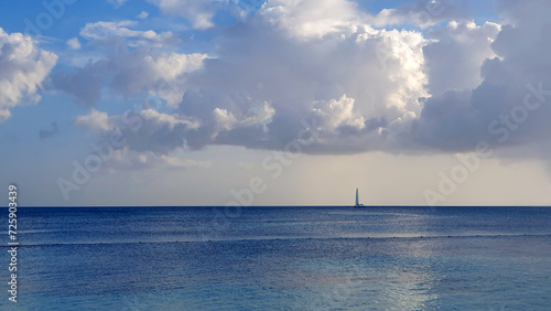 Tropical paradise beach with white clouds and blue caribbean sea.