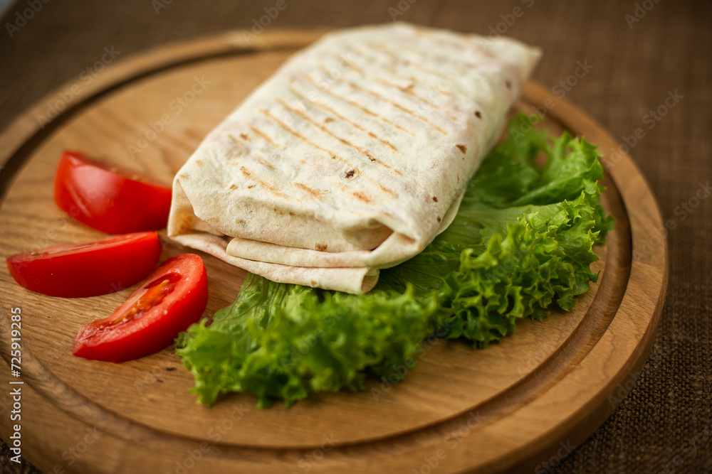 Turkish borek rolls with spinach and cheese on the white plate. A traditional Turkish pastry, Turkish name; rulo borek or sigara boregi. Turkish borek rolls with spinach and cheese on the white plate. A traditional Turkish pastry, Turkish name; rulo borek or sigara boregi.