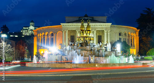Night view of grandiose composition of Colchis Fountain on main square of Kutaisi on background of Lado Meskhishvili State Academic Theatre in spring, Georgia photo