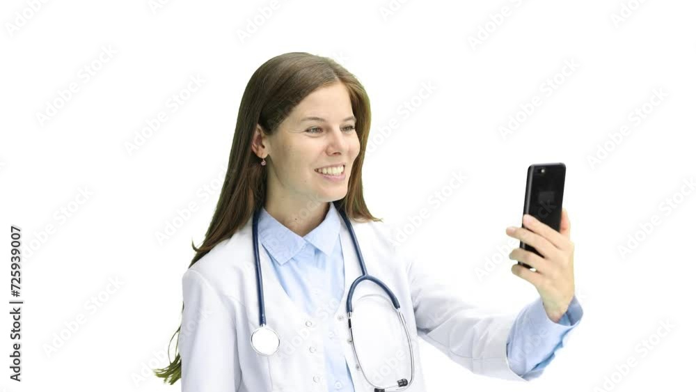 Female doctor, close-up, on a white background, with a phone Female doctor, close-up, on a white background, with a phone